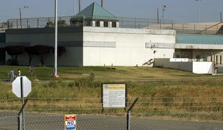 FILE - The Federal Correctional Institution is shown in Dublin, Calif., July 20, 2006. Nearly 100 federal Bureau of Prisons employees have been arrested, convicted or sentenced in criminal cases since the start of 2019, accused of crimes from smuggling drugs and weapons to stealing prison property, sexually assaulting inmates and murder. Those arrested include Ray Garcia, the warden at the Federal Correctional Institution at Dublin. (AP Photo/Ben Margot, File)
