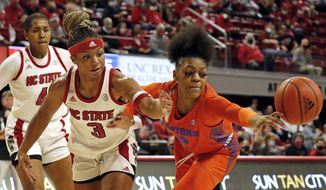NC State&#39;s Kai Crutchfield, front left, battles Florida&#39;s Lavender Briggs, right, for the ball during the first half of an NCAA college basketball game, Sunday, Nov. 14, 2021 in Raleigh, N.C. (AP Photo/Karl B. DeBlaker) **FILE**