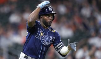 FILE -Tampa Bay Rays&#39; Randy Arozarena watches his home run against the Houston Astros during the ninth inning of a baseball game Sept. 28, 2021, in Houston. Arozarena won AL Rookie of the Year honor on Monday night, Nov. 15. (AP Photo/David J. Phillip, File)