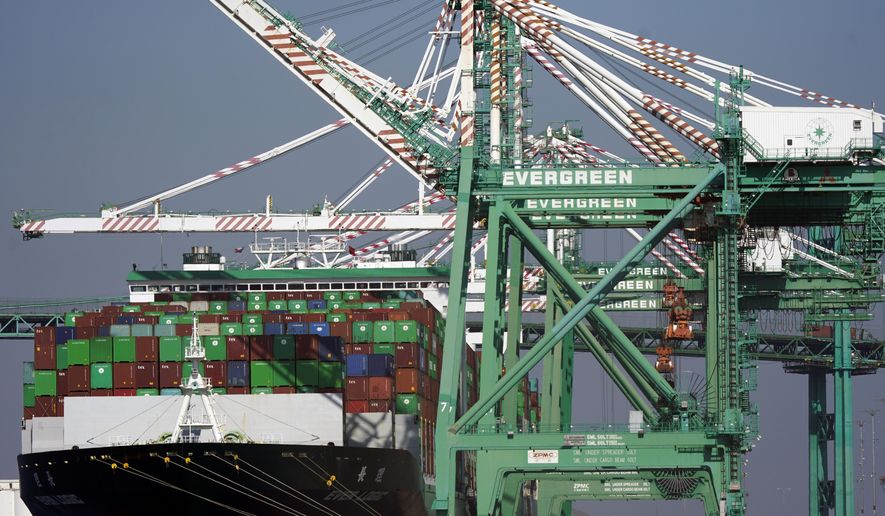 A cargo ship stacked with shipping containers is docked at the Port of Los Angeles on Wednesday, Nov. 10, 2021, in Los Angeles. Experts say unless more spending shifts back to services or something else motivates people to stop buying, it could take well into next year or even 2023 before the U.S. and global supply chains return to some semblance of normal. (AP Photo/Marcio Jose Sanchez) **FILE**