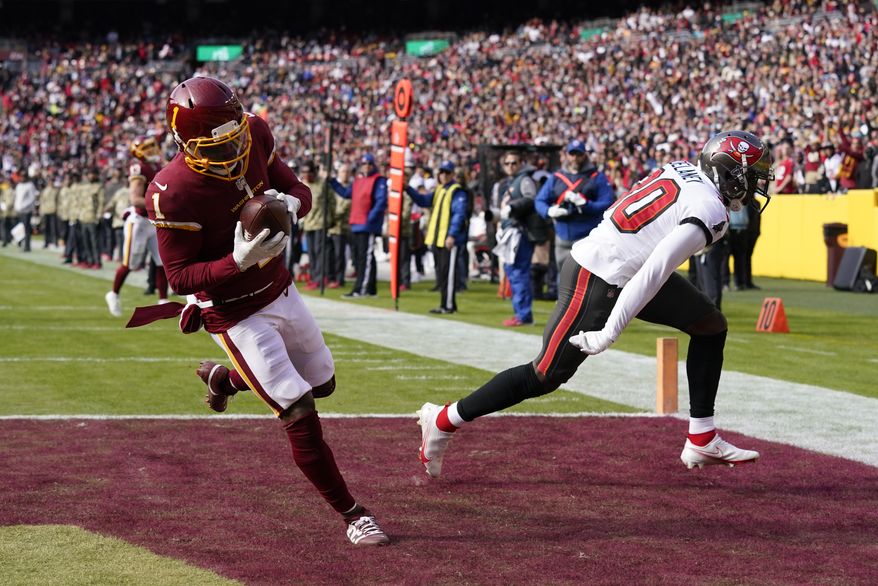 Washington Football Team wide receiver DeAndre Carter, left, scores a touchdown in front of Tampa Bay Buccaneers defensive back Dee Delaney during the first half of an NFL football game Sunday, Nov. 14, 2021, in Landover, Md. (AP Photo/Patrick Semansky) **FILE**
