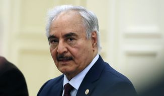 Libyan Gen. Khalifa Hifter joins a meeting with the Greek Foreign Minister Nikos Dendias in Athens, Greece, Jan. 17, 2020. Libya’s powerful commander, Khalifa Hifter, filed Tuesday, Nov. 16, 2021, as a candidate in the country’s presidential elections next month, as the long-waited vote faces growing uncertainty. Hifter submitted his candidacy papers in the eastern city of Benghazi and announced the move in a video. (AP Photo/Thanassis Stavrakis, File)
