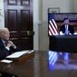 President Joe Biden, left, speaks as he meets virtually with Chinese President Xi Jinping, on screen, from the Roosevelt Room of the White House in Washington, Monday, Nov. 15, 2021. (AP Photo/Susan Walsh)