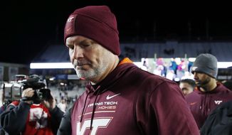Virginia Tech head coach Justin Fuente walks off the field after losing to Boston College during an NCAA college football game, Friday, Nov. 5, 2021, in Boston. Virginia Tech and football coach Justin Fuente have mutually agreed to part ways with two games left in his sixth season with the Hokies. In a statement, athletic director Whit Babcock said co-defensive line coach and recruiting coordinator J,C. Price will lead the Hokies through their final two regular season games. (AP Photo/Michael Dwyer, File) **FILE**