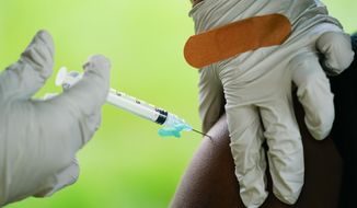 A health worker administers a dose of a Pfizer COVID-19 vaccine during a vaccination clinic at the Reading Area Community College in Reading, Pa., Tuesday, Sept. 14, 2021. (AP Photo/Matt Rourke, File)