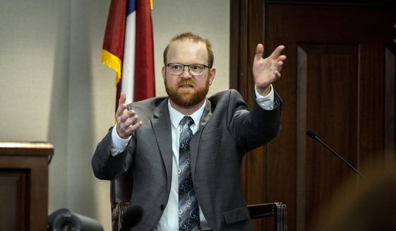 Travis McMichael speaks from the witness stand during his trial Wednesday, Nov. 17, 2021, in Brunswick, Ga. McMichael, his father Greg McMichael and their neighbor, William &amp;quot;Roddie&amp;quot; Bryan, are charged with the February 2020 death of 25-year-old Ahmaud Arbery. (AP Photo/Stephen B. Morton, Pool)