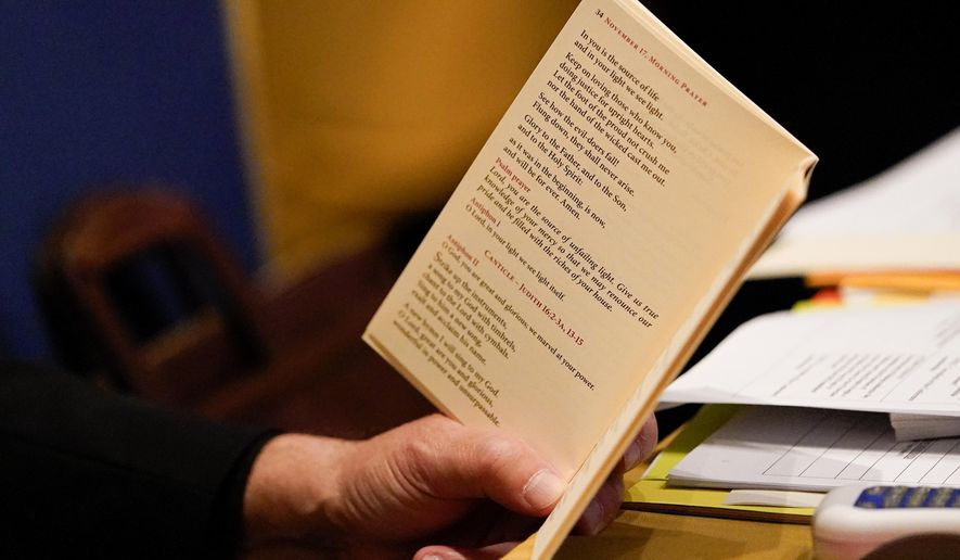 Bishop Manuel Cruz, of the Roman Catholic Archdiocese of Newark, N.J., reads scripture during a morning prayer at the Fall General Assembly meeting of the United States Conference of Catholic Bishops, Wednesday, Nov. 17, 2021, in Baltimore. (AP Photo/Julio Cortez)