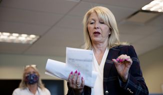 A multiagency task force executed search warrants Tuesday, Nov. 16, 2021, at four locations in western Colorado amid an ongoing investigation into allegations that Mesa County Clerk Tina Peters was involved in a security breach of elections equipment earlier this year. (McKenzie Lange/The Grand Junction Daily Sentinel via AP, File)