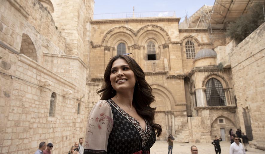Andrea Meza, the reigning Miss Universe from Mexico, poses in front of the Church of the Holy Sepulchre as she tours the Old City of Jerusalem, Wednesday, Nov. 17, 2021, ahead of the 70th Miss Universe pageant being staged in the southern Israeli resort city of Eilat next month. She said Wednesday that the long-running beauty pageant shouldn&#39;t be politicized, even as its next edition is being held in Israel and contestants have faced pressure to drop out in solidarity with the Palestinians. (AP Photo/Maya Alleruzzo)