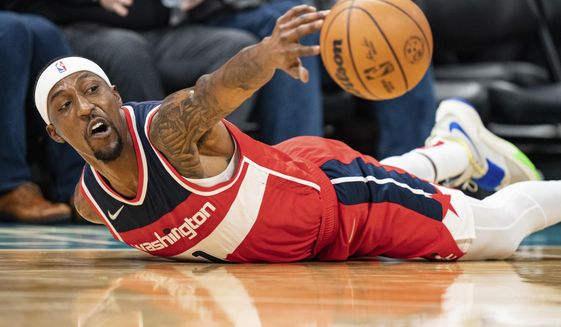 Washington Wizards guard Kentavious Caldwell-Pope (1) dives for the ball during the second half of an NBA basketball game against the Charlotte Hornets in Charlotte, N.C., Wednesday, Nov. 17, 2021. (AP Photo/Jacob Kupferman)