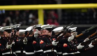 The Marine Corps Silent Drill Platoon performs during halftime of an NFL football game between the Atlanta Falcons and the New England Patriots, Thursday, Nov. 18, 2021, in Atlanta. (AP Photo/John Bazemore) **FILE**