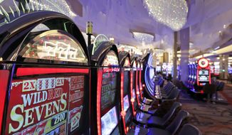 In this Friday, Dec. 2, 2016, file photo, slot machines in the casino are seen during a preview tour of the MGM National Harbor, Friday, Dec. 2, 2016 in Oxon Hill, Md. A Maryland commission approved in-person sports betting licenses at five casinos on Thursday, Nov. 18, 2021. The Sports Wagering Application Review Commission voted 5-2 for the licenses at MGM National Harbor in Oxon Hill, Live! Casino &amp; Hotel in Hanover, Horseshoe Casino in Baltimore, Hollywood Casino in Perryville and Ocean Downs Casino in Berlin. (AP Photo/Alex Brandon, File) **FILE**