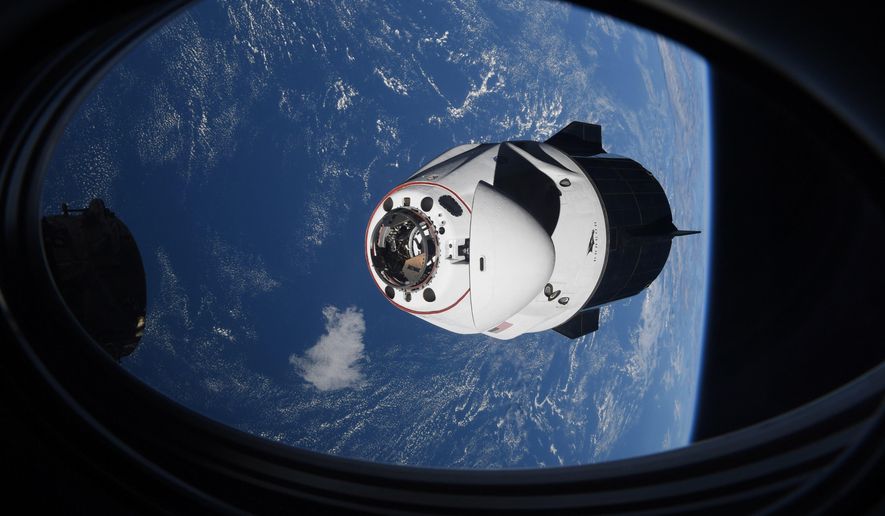 In this Saturday, April 24, 2021, photo made available by NASA, the SpaceX Crew Dragon capsule approaches the International Space Station for docking.   NASA says the International Space Station remains at increased risk from orbiting debris following this week&#39;s Russian weapons test. On Monday, Nov. 15, 2021, Russia used a missile to destroy a satellite in an orbit just above the space station. (NASA via AP) **FILE**