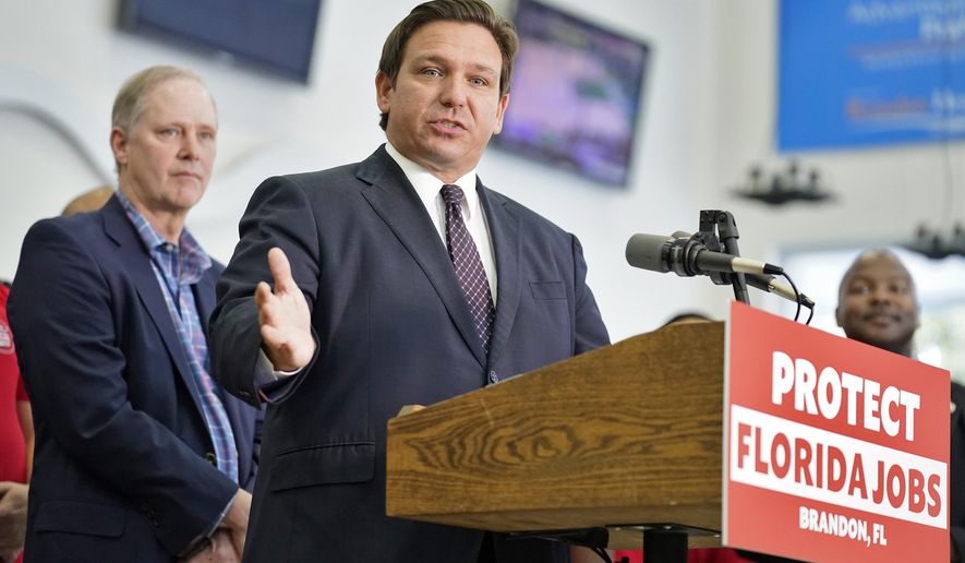 Florida Gov. Ron DeSantis speaks to supporters and members of the media after a bill signing Thursday, Nov. 18, 2021, in Brandon, Fla. DeSantis signed a bill that protects employees and their families from coronavirus vaccine and mask mandates. (AP Photo/Chris O&#x27;Meara)