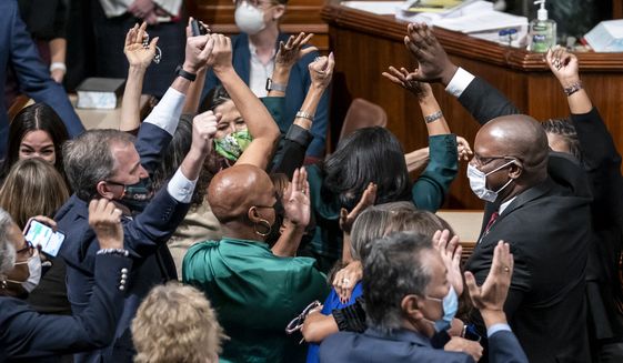Democrats celebrate in the chamber as the House approves a sweeping social and environment bill, giving a victory to President Joe Biden, at the Capitol in Washington, Friday, Nov. 19, 2021. (AP Photo/J. Scott Applewhite)