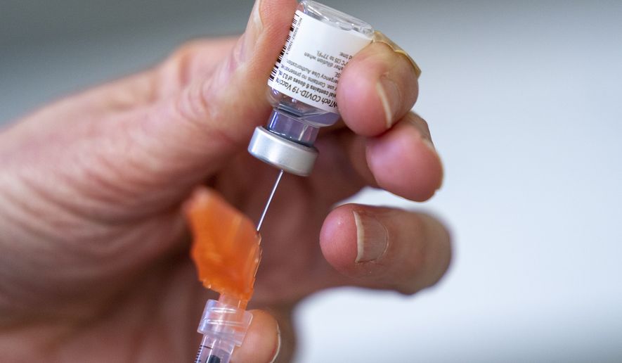 A syringe is loaded with the Pfizer COVID-19 vaccine at a clinic in Richmond, British Columbia, Canada on April 10, 2021. Canada&#x27;s health regulator has approved Pfizer&#x27;s kid-size COVID-19 shot, Friday, Nov. 19. (Jonathan Hayward/The Canadian Press via AP, File)  **FILE**