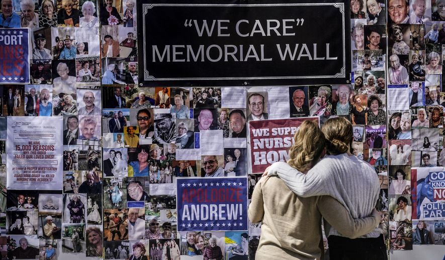 In this file photo, Theresa Sari, left, and her daughter Leila Ali look at a protest-memorial wall for nursing home residents who died from COVID-19, including Sari&#x27;s mother Maria Sachse, March 21, 2021, in New York. A state Assembly committee investigation found former New York Gov. Andrew Cuomo&#x27;s administration made a political decision to misrepresent how many nursing home residents died of COVID-19. (AP Photo/Seth Wenig, File)