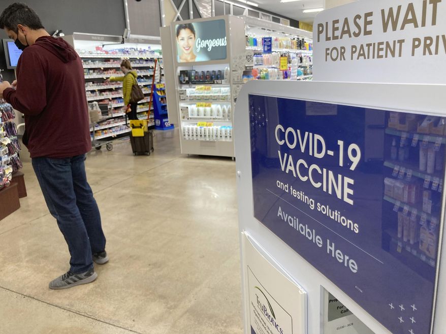 FILE - A patient waits to be called for a COVID-19 vaccination booster shot outside a pharmacy in a grocery store, on Nov. 3, 2021, in downtown Denver.   U.S. regulators have opened up COVID-19 booster shots to all and more adults, Friday, Nov. 19, letting them choose another dose of either the Pfizer or Moderna vaccine. (AP Photo/David Zalubowski, File)