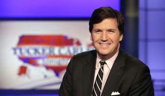 Tucker Carlson, host of &quot;Tucker Carlson Tonight,&quot; poses for photos in a Fox News Channel studio, in New York. (AP Photo/Richard Drew)