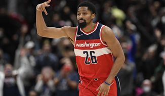 Washington Wizards guard Spencer Dinwiddie (26) gestures after he made a three-point basket during the second half of an NBA basketball game against the Miami Heat, Saturday, Nov. 20, 2021, in Washington. The Wizards won 103-100. (AP Photo/Nick Wass)