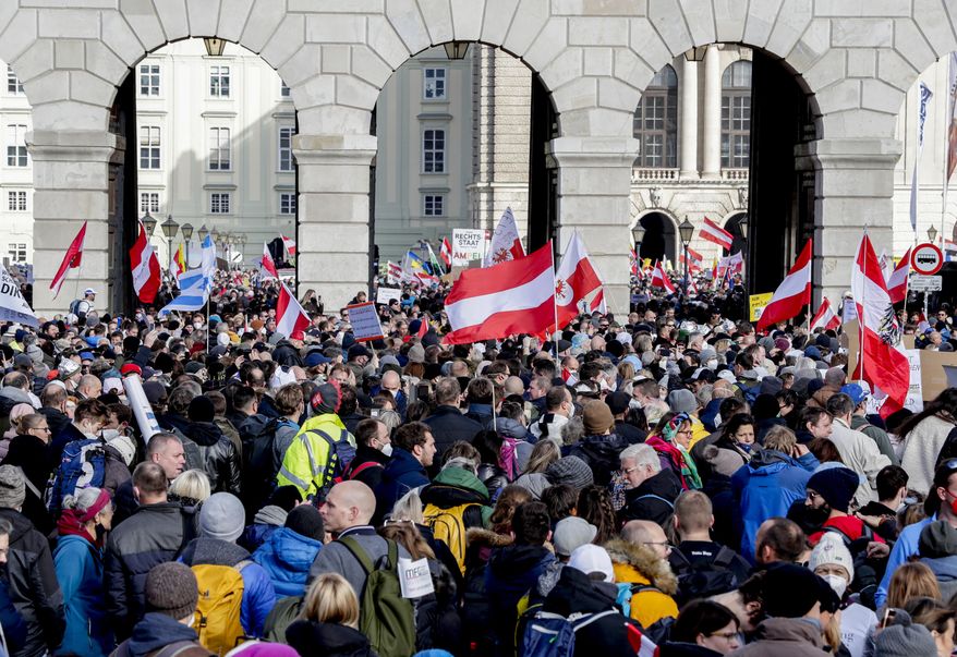 CORRECTS DATE - People take part in a demonstration against the country's coronavirus restrictions in Vienna, Austria, Saturday, Nov. 20, 2021. Thousands of protesters are expected to gather in Vienna after the Austrian government announced a nationwide lockdown to contain the quickly rising coronavirus infections in the country. (AP Photo/Lisa Leutner)