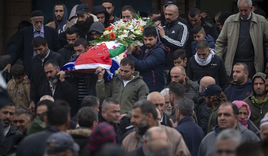 Palestinians carry the body of Isra Khazimia who was killed by Israeli fire after allegedly trying to stab an officer in Jerusalem&#39;s Old in September, during her funeral in the West Bank village of Qabatiya, Saturday, Nov. 20, 2021. Israel had withheld the body of Khazimia through its controversial policy of holding the remains of Palestinians killed while reportedly carrying out attacks, although agreed to return her to her family on &amp;quot;humanitarian grounds.&amp;quot; At the time of her alleged attacks, Khazimia was reported to have had mental health issues.(AP Photo/Majdi Mohammed)