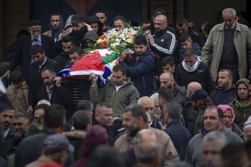 Palestinians carry the body of Isra Khazimia who was killed by Israeli fire after allegedly trying to stab an officer in Jerusalem&#39;s Old in September, during her funeral in the West Bank village of Qabatiya, Saturday, Nov. 20, 2021. Israel had withheld the body of Khazimia through its controversial policy of holding the remains of Palestinians killed while reportedly carrying out attacks, although agreed to return her to her family on &amp;quot;humanitarian grounds.&amp;quot; At the time of her alleged attacks, Khazimia was reported to have had mental health issues.(AP Photo/Majdi Mohammed)