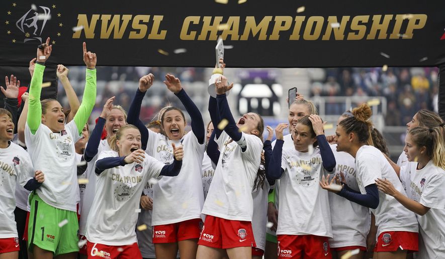 Washington Spirit players celebrate with the trophy after defeating Chicago Red Stars in the NWSL Championship soccer match, Saturday, Nov. 20, 2021, in Louisville, Ky. (AP Photo/Jeff Dean) **FILE**