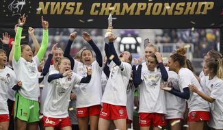 Washington Spirit players celebrate with the trophy after defeating Chicago Red Stars in the NWSL Championship soccer match, Saturday, Nov. 20, 2021, in Louisville, Ky. (AP Photo/Jeff Dean)