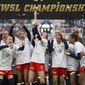 Washington Spirit players celebrate with the trophy after defeating Chicago Red Stars in the NWSL Championship soccer match, Saturday, Nov. 20, 2021, in Louisville, Ky. (AP Photo/Jeff Dean) **FILE**