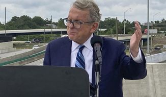 In this July 13, 2021 file photo, Ohio Gov. Mike DeWine promotes a new entrance ramp onto I-70 in downtown Columbus, Ohio.  DeWine signed into law a map of new congressional districts on Saturday, Nov. 20,  despite objections from Democrats and voting rights groups. The map will be in effect for the next four years. (AP Photo/Andrew Welsh-Huggins, File)FILE