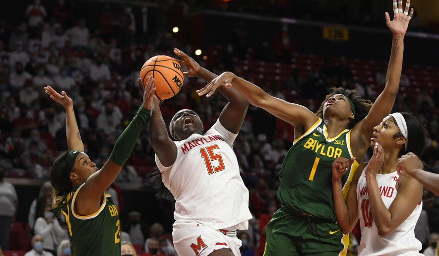 Maryland guard Ashley Owusu (15) goes to the basket against Baylor guard Sarah Andrews (24) and forward NaLyssa Smith (1) during the second half of an NCAA college basketball game, Sunday, Nov. 21, 2021, in College Park, Md. Maryland forward Angel Reese , right, looks on. (AP Photo/Nick Wass)