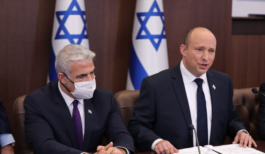 Israeli Prime Minister Naftali Bennett, right, and Foreign Minister Yair Lapid attend a cabinet meeting at the Prime minister&#39;s office in Jerusalem, Sunday, Nov. 21, 2021. (Abir Sultan/Pool via AP)