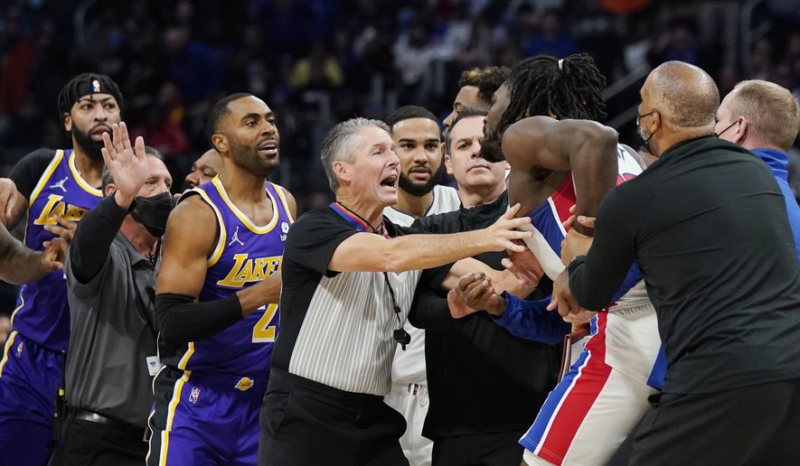 Players separate Detroit Pistons center Isaiah Stewart from Los Angeles Lakers forward LeBron James, not in frame, during the second half of an NBA basketball game, Sunday, Nov. 21, 2021, in Detroit. (AP Photo/Carlos Osorio) **FILE**