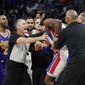 Players separate Detroit Pistons center Isaiah Stewart from Los Angeles Lakers forward LeBron James, not in frame, during the second half of an NBA basketball game, Sunday, Nov. 21, 2021, in Detroit. (AP Photo/Carlos Osorio) **FILE**