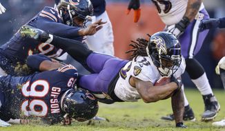 Baltimore Ravins&#39; Devonta Freeman(33) dives for yardage against the Chicago Bears during an NFL football game Sunday, Nov 21. 2021, in Chicago. (AP Photo/Jeffrey Phelps)