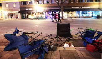 Toppled chairs line W. Main St. in downtown Waukesha, Wis., after an SUV drove into a parade of Christmas marchers on Sunday, Nov. 21, 2021. (John Hart/Wisconsin State Journal via AP)