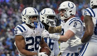 Indianapolis Colts running back Jonathan Taylor (28) celebrates with Carson Wentz (2) after scoring during the second half of an NFL football game against the Buffalo Bills in Orchard Park, N.Y., Sunday, Nov. 21, 2021. (AP Photo/Adrian Kraus) **FILE**