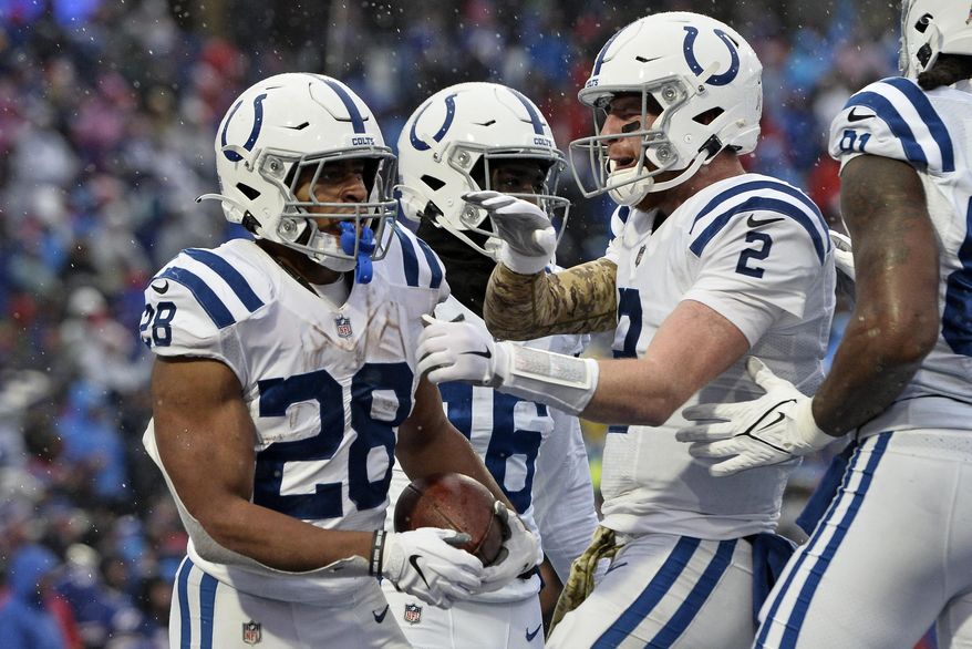 Indianapolis Colts running back Jonathan Taylor (28) celebrates with Carson Wentz (2) after scoring during the second half of an NFL football game against the Buffalo Bills in Orchard Park, N.Y., Sunday, Nov. 21, 2021. (AP Photo/Adrian Kraus) **FILE**
