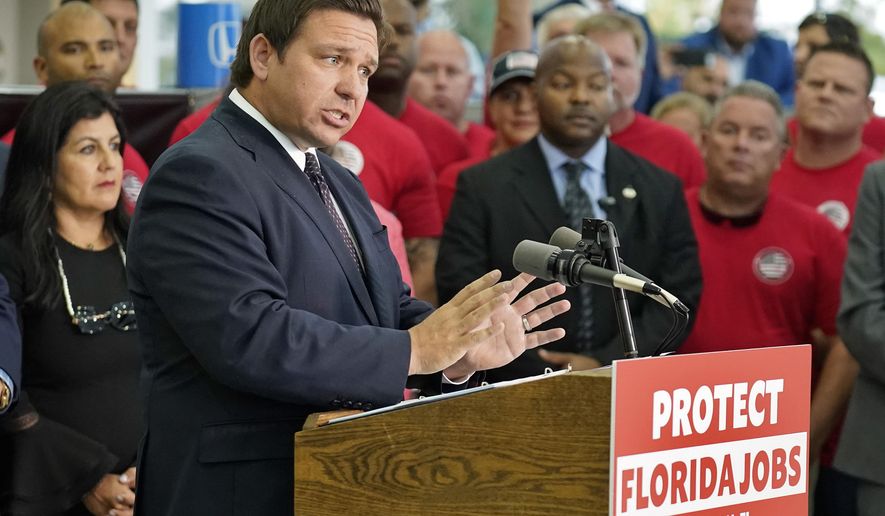 Florida Gov. Ron DeSantis speaks to supporters and members of the media before a bill signing Thursday, Nov. 18, 2021, in Brandon, Fla. DeSantis signed a bill that protects employees and their families from coronavirus vaccine and mask mandates. (AP Photo/Chris O&#39;Meara)