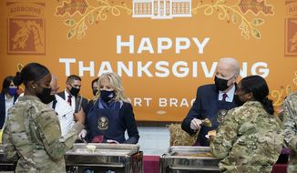 President Joe Biden and first lady Jill Biden serve dinner during a visit to Fort Bragg to mark the upcoming Thanksgiving holiday, Monday, Nov. 22, 2021, in Fort Bragg, N.C. (AP Photo/Evan Vucci)