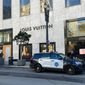 Police officers and emergency crews park outside the Louis Vuitton store in San Francisco&#39;s Union Square on Nov. 21, 2021, after looters ransacked businesses. (Danielle Echeverria/San Francisco Chronicle via AP, File)
