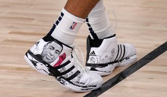 FILE - A depiction of George Floyd is seen on the shoes of Denver Nuggets&#39; Jamal Murray (27) during the second half an NBA first round playoff basketball game against the Utah Jazz on Tuesday, Sept. 1, 2020, in Lake Buena Vista, Fla. (AP Photo/Mark J. Terrill, File)