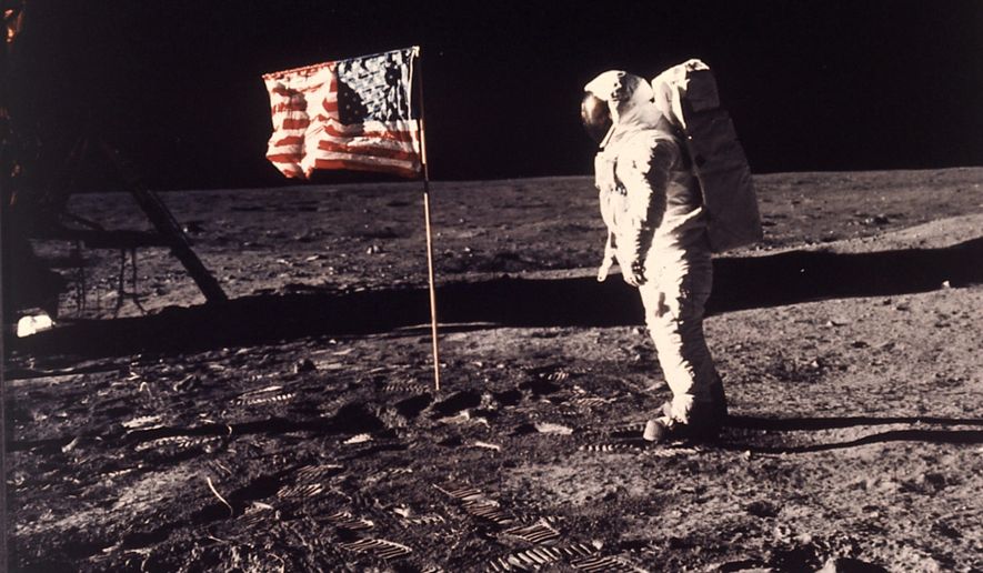 Astronaut Edwin E. 'Buzz' Aldrin Jr. stands next to a U.S. flag planted on the moon during the Apollo 11 mission on July 20, 1969. (Neil A. Armstrong/NASA via AP, File)