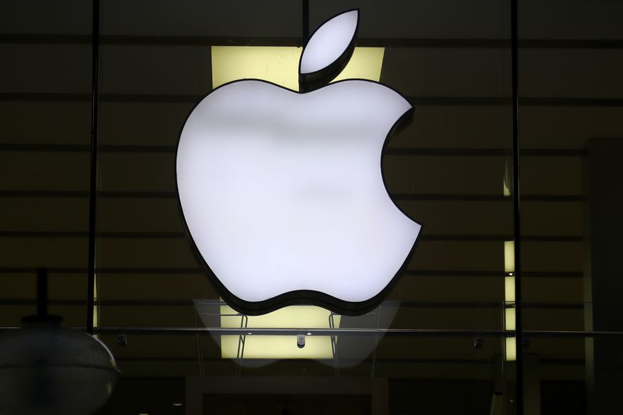The logo of Apple is illuminated at a store in the city center in Munich, Germany, on Dec. 16, 2020. Italy&#39;s antitrust watchdog has fined Apple and Amazon more than 200 million euros ($225 million) for cooperating to restrict competition in the sale of Apple and Beats branded products, in violation of European Union rules. The Italian Competition Authority said Tuesday, Nov. 23, 2021 that its investigation found that under a 2018 agreement between the U.S. tech giants, contractual provisions limited access to the Amazon.it marketplace to selected resellers.  (AP Photo/Matthias Schrader, File)  **FILE**