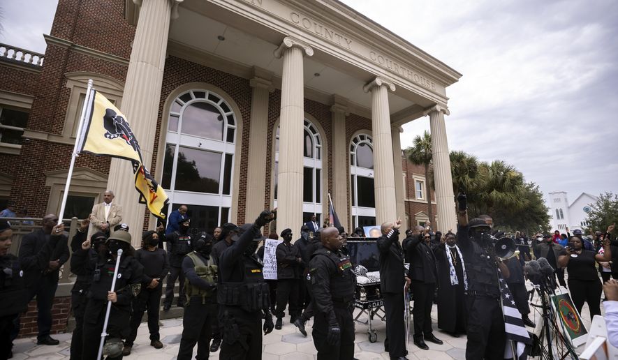 Dozens of Black Lives Matter and Black Panther protesters gather outside the Glynn County Courthouse where the trial of Travis McMichael, his father, Gregory McMichael, and William &amp;quot;Roddie&amp;quot; Bryan is held, Monday, Nov. 22, 2021, in Brunswick, Ga. The three men are charged with the February 2020 slaying of 25-year-old Ahmaud Arbery. (AP Photo/Stephen B. Morton)
