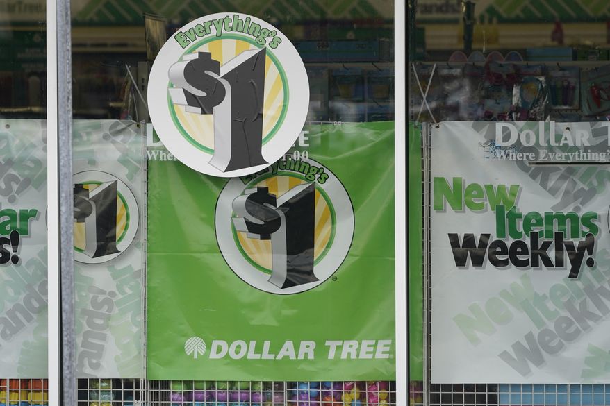 FILE - Dollar Tree store logos indicating that everything in the store is for $1 are promoted on a storefront window on Feb. 25, 2021, in Jackson, Miss. Faced with the rising cost of goods and freight, discount retail chain Dollar Tree said Tuesday, Nov. 23, 2021, it will be raising its prices to $1.25 for the majority of its products. (AP Photo/Rogelio V. Solis, File)