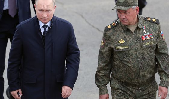 FILE - Russian President Vladimir Putin, left, and Russian Defense Minister Sergei Shoigu arrive to attend the joint strategic exercise of the armed forces of the Russian Federation and the Republic of Belarus Zapad-2021 at the Mulino training ground in the Nizhny Novgorod region, Russia, on Sept. 13, 2021. Ukrainian and Western officials are worried that a Russian military buildup near Ukraine could signal plans by Moscow to invade its ex-Soviet neighbor. The Kremlin insists it has no such intention and has accused Ukraine and its Western backers of making the claims to cover up their own allegedly aggressive designs. (Sergei Savostyanov, Sputnik, Kremlin Pool Photo via AP, File)