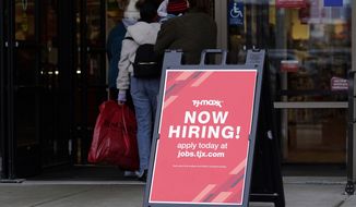 Hiring sign is displayed outside of a retail store in Vernon Hills, Ill., Saturday, Nov. 13, 2021.  The number of Americans applying for unemployment benefits plummeted last week to the lowest level in more than half a century, another sign that the U.S. job market is rebounding rapidly from last years coronavirus recession.  (AP Photo/Nam Y. Huh)
