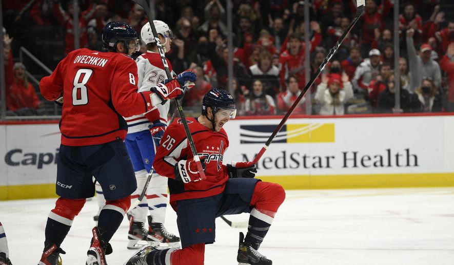 Washington Capitals center Nic Dowd, front right, celebrates his goal next to left wing Alex Ovechkin (8) during the first period of an NHL hockey game, as Montreal Canadiens defenseman Jeff Petry, center back, skates by, Wednesday, Nov. 24, 2021, in Washington. (AP Photo/Nick Wass)